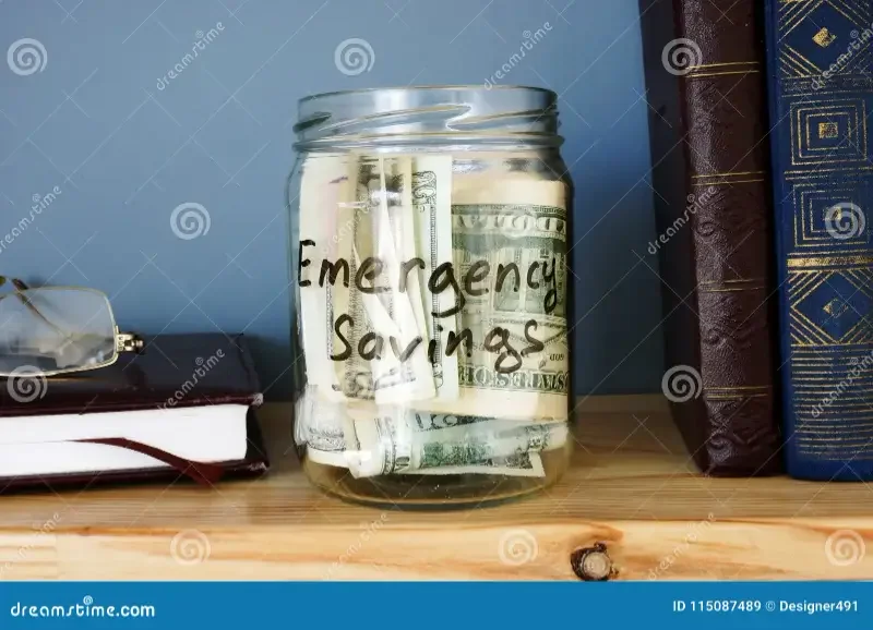 How Much of Your Paycheck Should You Save? (2026 US Guide) 2 Glass jar filled with cash representing an emergency savings fund